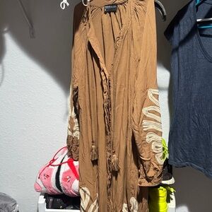 This is a brown casual dress with embroidered sleeves by the brand Marwa.